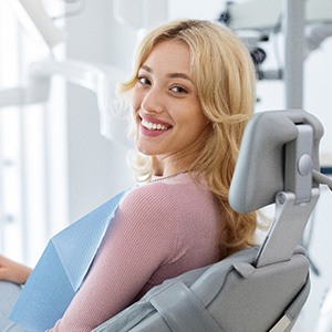 Woman smiling while sitting in treatment chair