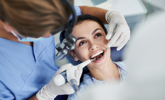 Hygienist offering advanced dental hygiene