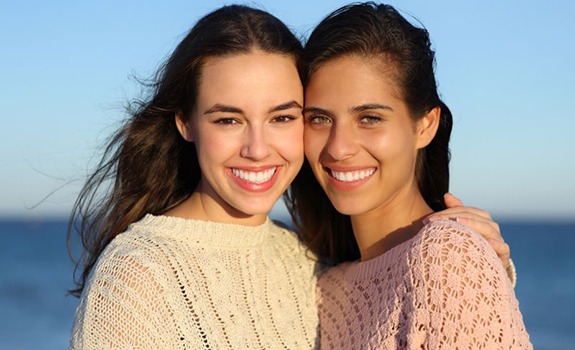 Two smiling young women with beautiful teeth