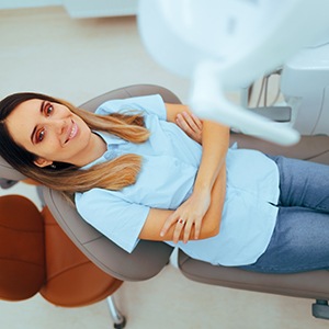 Patient smiling while sitting in treatment chair
