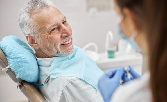 a dentist speaking to a patient