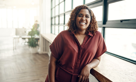 a woman leaning against a tall tabletop