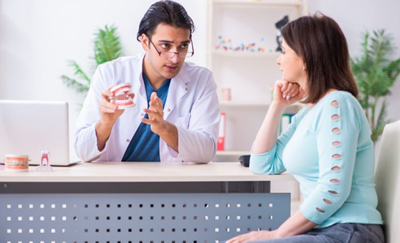 Dentist talking to female patient