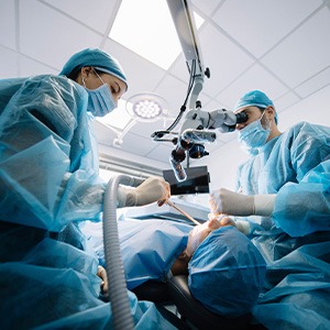 Dentists performing a dental implant surgery